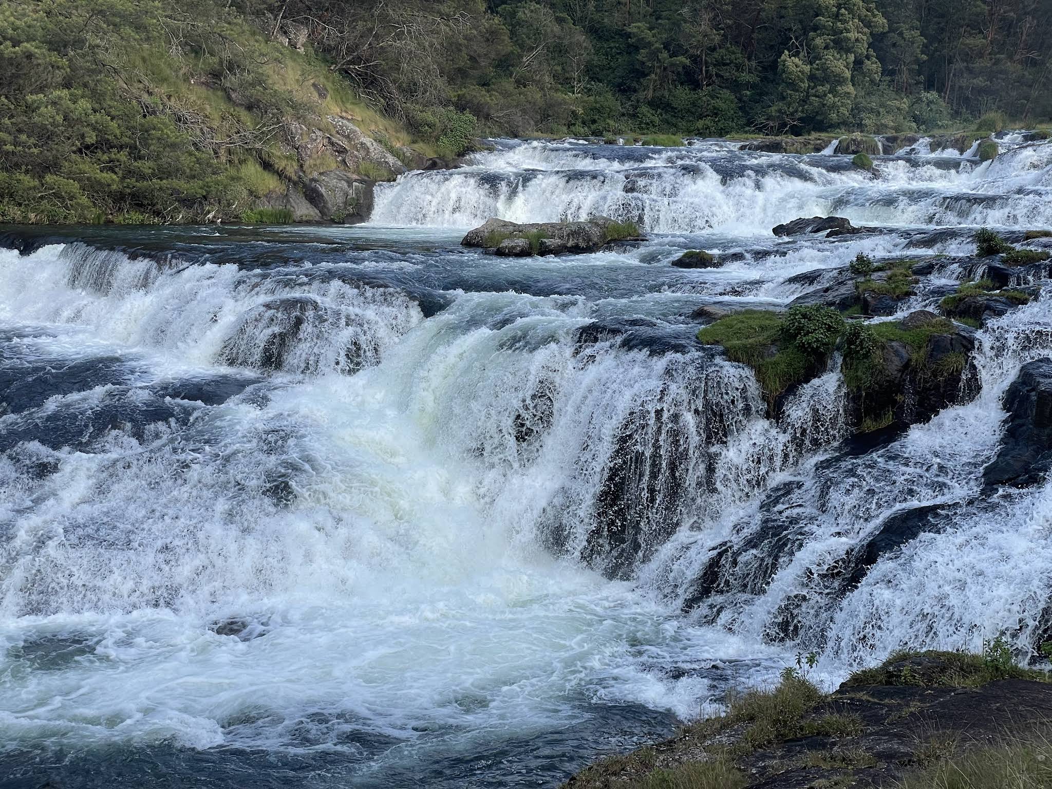 Layered waterfalls cascading down rocks in Pykara